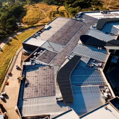 Aerial view of Powermode's solar PV installation on a mall rooftop, harnessing sustainable energy for commercial operations.